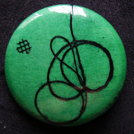 Badge Tournoiement Noir sur Vert